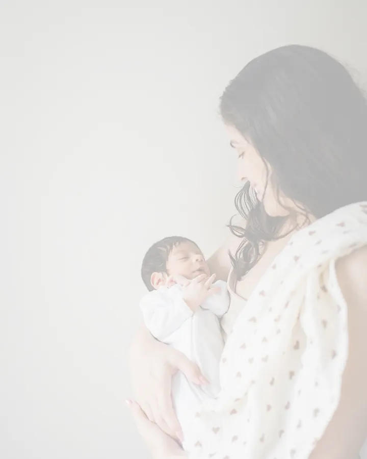Sapir, attachment-based sleep consultant, holding her newborn daughter